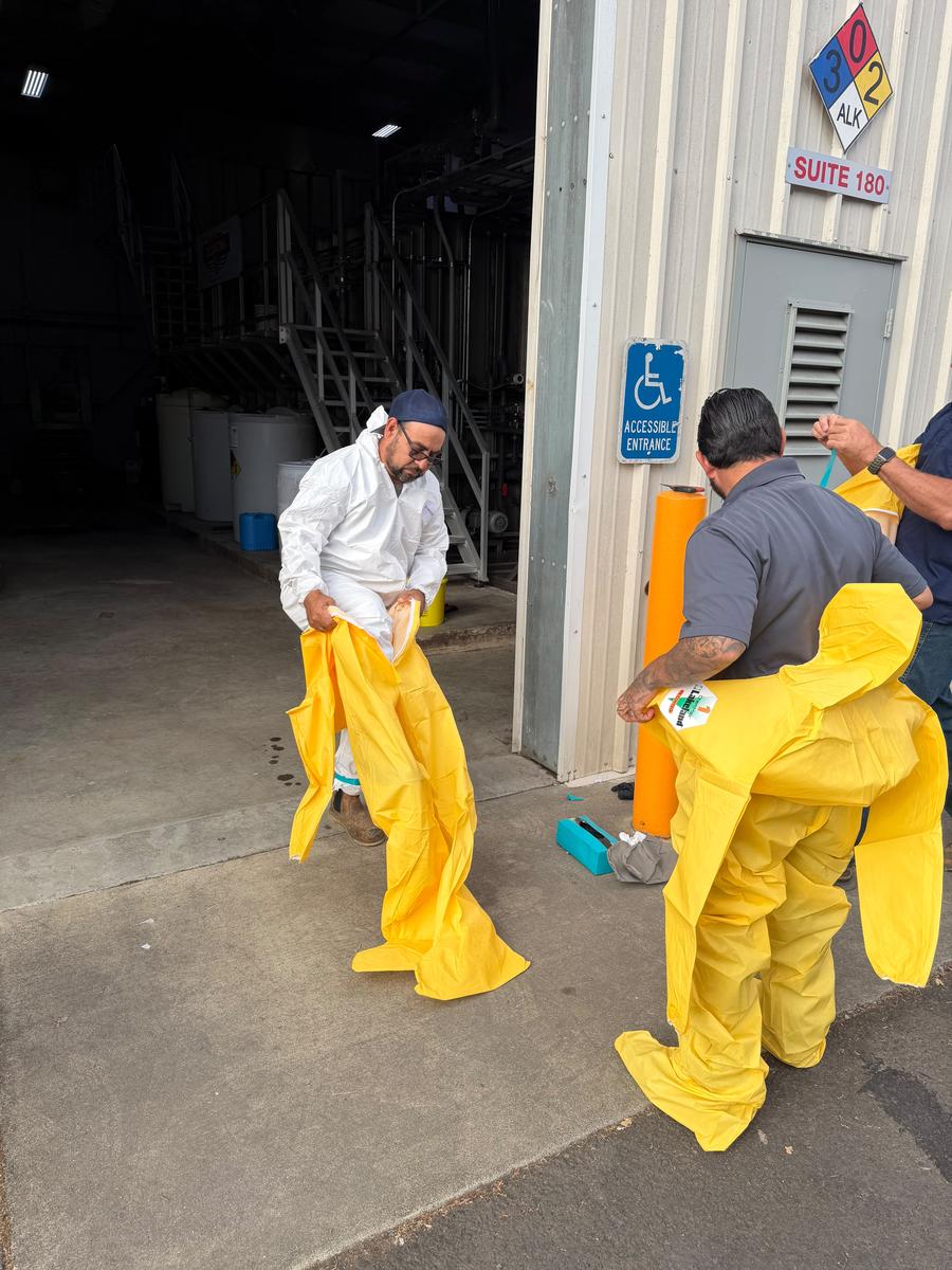 Allied biohazard technician suiting up for decontamination